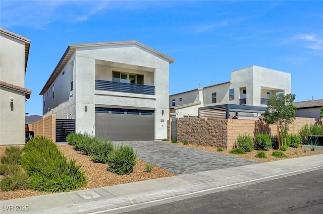 2670 Skylark Trail St, Henderson, NV 89044 - contemporary house featuring a garage, a balcony, stucco siding, and driveway