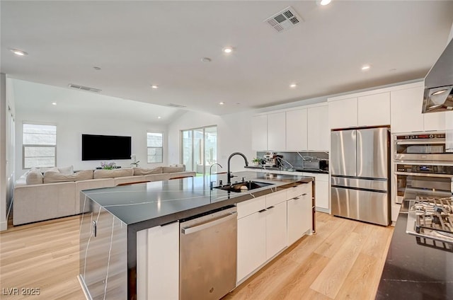 2670 Skylark Trail St, Henderson, NV 89044 - kitchen with stainless steel appliances, light wood-style floors, healthy amount of natural light, white cabinets, and recessed lighting