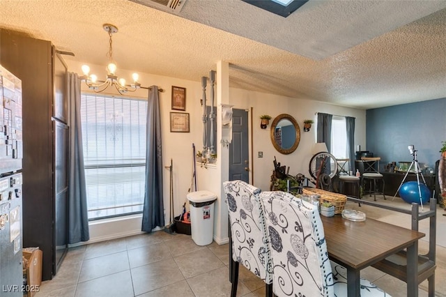 4300 N Lamont St Unit 275, Las Vegas, NV 89115 - dining room featuring a chandelier, a textured ceiling, and light tile patterned floors