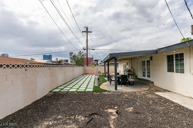 1705 Ivanhoe Way, Las Vegas, NV 89102 - fenced backyard with french doors and a patio area