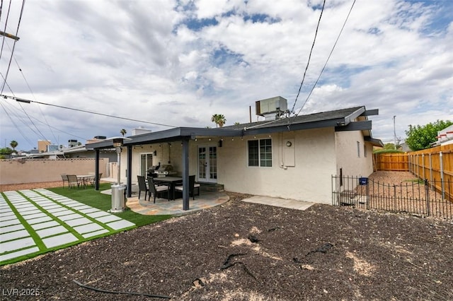 1705 Ivanhoe Way, Las Vegas, NV 89102 - rear view of house with french doors, stucco siding, a fenced backyard, and a patio area