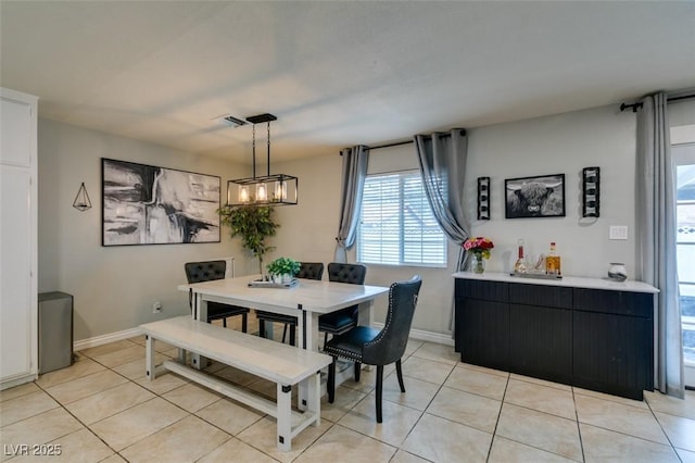 1705 Ivanhoe Way, Las Vegas, NV 89102 - dining room featuring light tile patterned flooring, a chandelier, and healthy amount of natural light