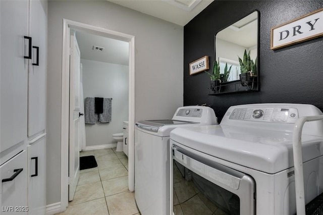 1705 Ivanhoe Way, Las Vegas, NV 89102 - laundry room featuring separate washer and dryer, cabinet space, and light tile patterned floors