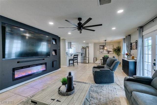 1705 Ivanhoe Way, Las Vegas, NV 89102 - living area with ceiling fan, light tile patterned flooring, recessed lighting, and a glass covered fireplace