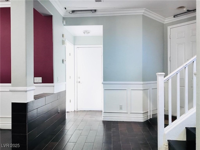 3009 Austin Pale Ave, North Las Vegas, NV 89081 - foyer featuring crown molding, stairs, a wainscoted wall, a decorative wall, and dark wood-type flooring