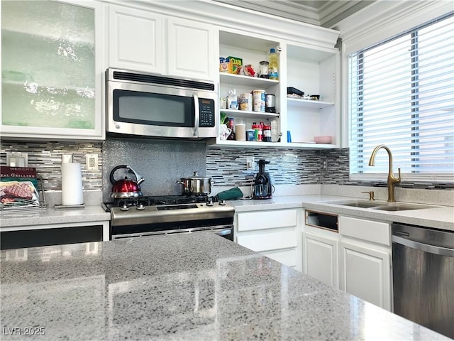 3009 Austin Pale Ave, North Las Vegas, NV 89081 - kitchen with appliances with stainless steel finishes, white cabinets, crown molding, glass insert cabinets, and backsplash