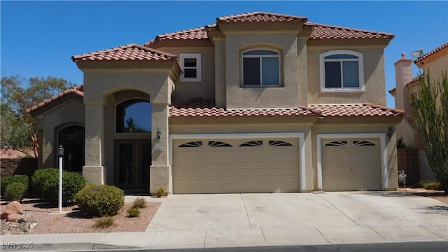 2587 Mizzoni Cir, Henderson, NV 89052 - mediterranean / spanish-style home with an attached garage, stucco siding, driveway, and a tiled roof