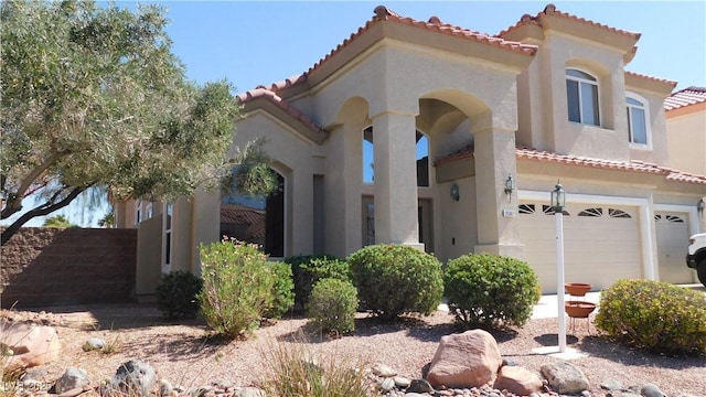 2587 Mizzoni Cir, Henderson, NV 89052 - mediterranean / spanish-style house with a tile roof, stucco siding, and a garage