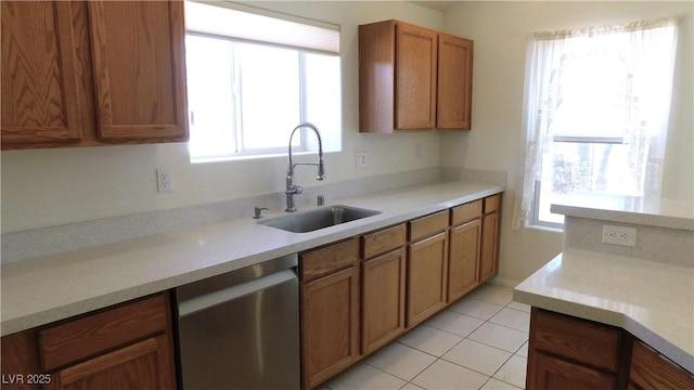 2587 Mizzoni Cir, Henderson, NV 89052 - kitchen with dishwasher, brown cabinets, light countertops, and light tile patterned floors