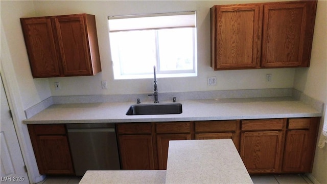 2587 Mizzoni Cir, Henderson, NV 89052 - kitchen featuring dishwasher, light countertops, and brown cabinetry