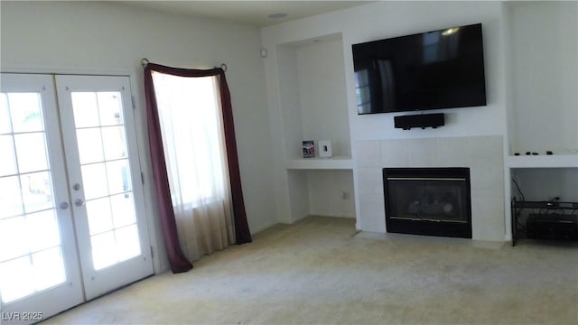 2587 Mizzoni Cir, Henderson, NV 89052 - living area featuring carpet floors, french doors, and a tiled fireplace