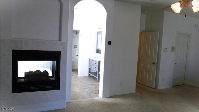 2587 Mizzoni Cir, Henderson, NV 89052 - carpeted living room with ceiling fan, a multi sided fireplace, and arched walkways