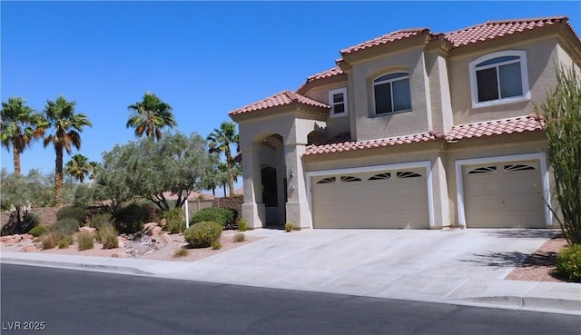 2587 Mizzoni Cir, Henderson, NV 89052 - mediterranean / spanish house with an attached garage, stucco siding, a tiled roof, and driveway