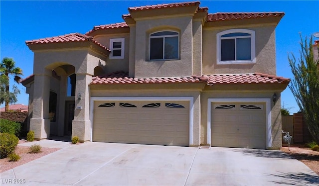 2587 Mizzoni Cir, Henderson, NV 89052 - mediterranean / spanish-style house featuring a garage, stucco siding, driveway, and a tile roof