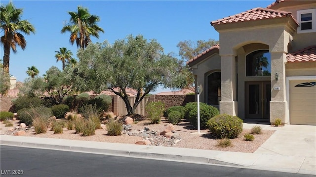 2587 Mizzoni Cir, Henderson, NV 89052 - view of front of home featuring a tile roof, stucco siding, driveway, and a garage