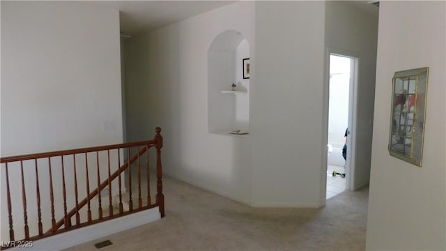2587 Mizzoni Cir, Henderson, NV 89052 - corridor featuring an upstairs landing, arched walkways, and carpet flooring