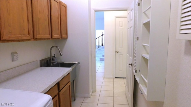 2587 Mizzoni Cir, Henderson, NV 89052 - kitchen featuring light tile patterned floors, brown cabinets, and light countertops