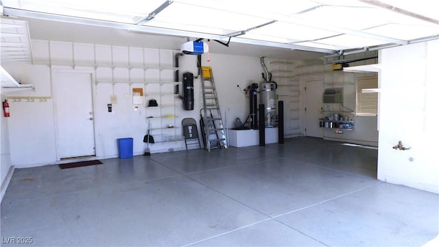 2587 Mizzoni Cir, Henderson, NV 89052 - garage featuring strapped water heater and a garage door opener