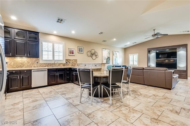 5681 Exotic Rosette Ave, Las Vegas, NV 89139 - kitchen with stainless steel dishwasher, healthy amount of natural light, ceiling fan, decorative backsplash, and lofted ceiling