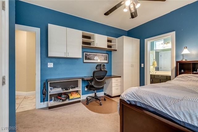 5681 Exotic Rosette Ave, Las Vegas, NV 89139 - bedroom with an office area, ensuite bathroom, light colored carpet, and ceiling fan