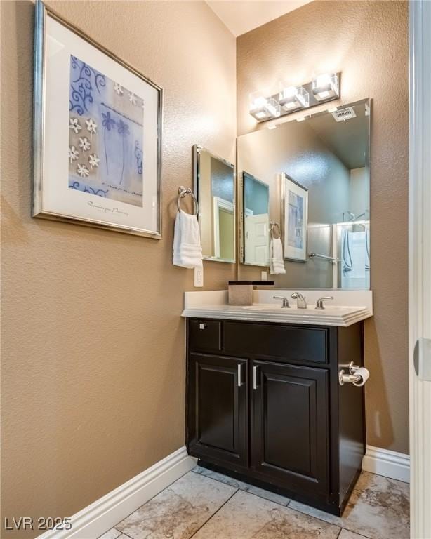 5681 Exotic Rosette Ave, Las Vegas, NV 89139 - bathroom with vanity and marble look tile flooring