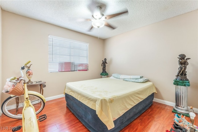 2666 Aarondavid Dr, Las Vegas, NV 89121 - bedroom with wood finished floors, a textured ceiling, and a ceiling fan