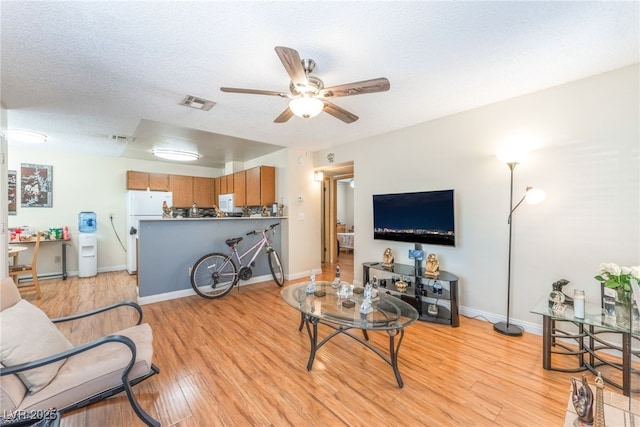 2666 Aarondavid Dr, Las Vegas, NV 89121 - living area featuring ceiling fan, light wood-style floors, and a textured ceiling