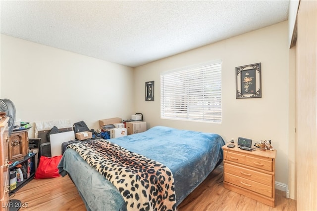 2666 Aarondavid Dr, Las Vegas, NV 89121 - bedroom featuring wood finished floors and a textured ceiling