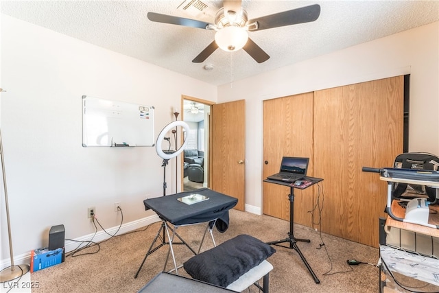 2666 Aarondavid Dr, Las Vegas, NV 89121 - exercise room with light colored carpet, a ceiling fan, and a textured ceiling