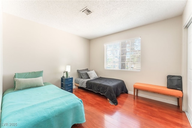 2666 Aarondavid Dr, Las Vegas, NV 89121 - bedroom featuring wood finished floors and a textured ceiling
