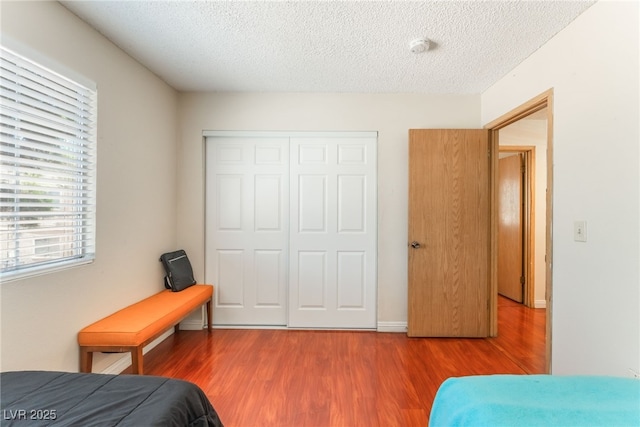 2666 Aarondavid Dr, Las Vegas, NV 89121 - bedroom with a closet, wood finished floors, and a textured ceiling