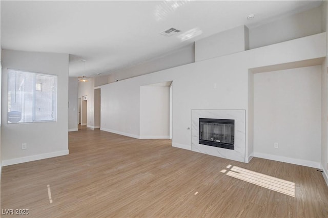 1005 Transom Dr, Las Vegas, NV 89128 - unfurnished living room with a premium fireplace and light wood-type flooring
