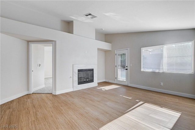 1005 Transom Dr, Las Vegas, NV 89128 - unfurnished living room with a premium fireplace, wood finished floors, and vaulted ceiling