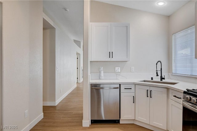 1005 Transom Dr, Las Vegas, NV 89128 - kitchen featuring appliances with stainless steel finishes, white cabinets, and light wood finished floors