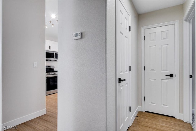 1005 Transom Dr, Las Vegas, NV 89128 - corridor featuring light wood finished floors and baseboards