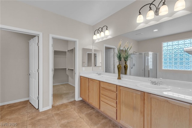 2244 Savannah River St, Henderson, NV 89044 - bathroom with a shower stall, double vanity, a spacious closet, and tile patterned flooring