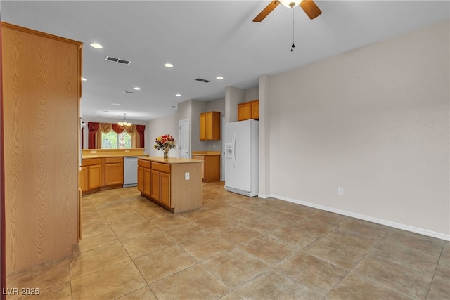 2244 Savannah River St, Henderson, NV 89044 - kitchen featuring white appliances, light countertops, a center island, ceiling fan, and recessed lighting