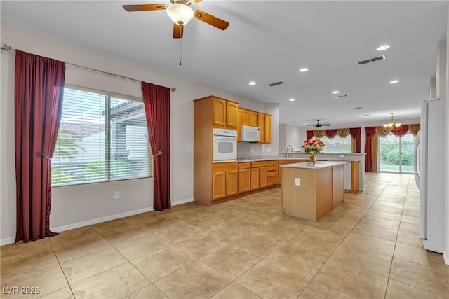 2244 Savannah River St, Henderson, NV 89044 - kitchen with white appliances, a ceiling fan, light countertops, light tile patterned floors, and recessed lighting