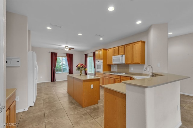 2244 Savannah River St, Henderson, NV 89044 - kitchen featuring white appliances, a kitchen island, light countertops, a ceiling fan, and recessed lighting