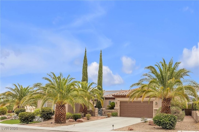 2244 Savannah River St, Henderson, NV 89044 - view of front of house featuring concrete driveway, an attached garage, stucco siding, and a tiled roof