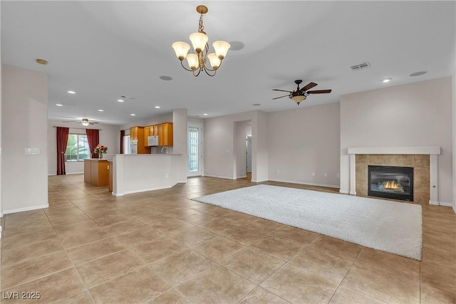 2244 Savannah River St, Henderson, NV 89044 - unfurnished living room featuring ceiling fan, light tile patterned floors, recessed lighting, a tile fireplace, and a chandelier