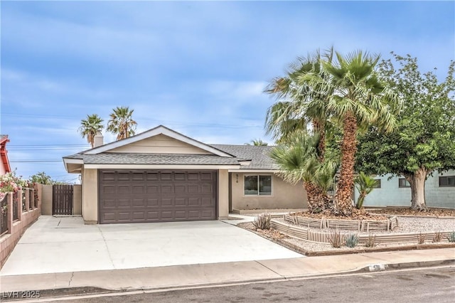516 Donner St, Las Vegas, NV 89107 - ranch-style house with a garage, stucco siding, concrete driveway, and a shingled roof