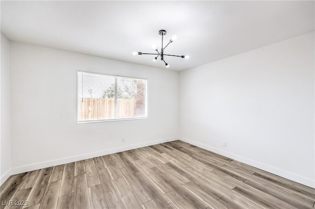 516 Donner St, Las Vegas, NV 89107 - empty room with a chandelier and light wood finished floors