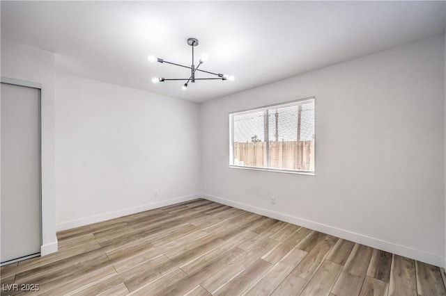 516 Donner St, Las Vegas, NV 89107 - empty room with a chandelier and light wood-type flooring