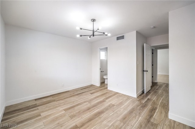 516 Donner St, Las Vegas, NV 89107 - unfurnished room featuring a chandelier, light wood-style floors, and a smoke detector