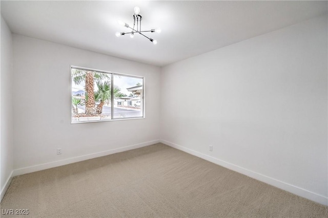 516 Donner St, Las Vegas, NV 89107 - carpeted empty room with a chandelier and baseboards