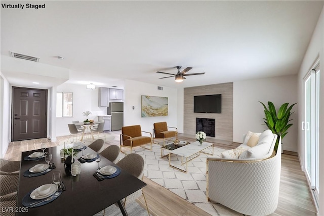 516 Donner St, Las Vegas, NV 89107 - living area featuring light wood-type flooring, ceiling fan, and a fireplace