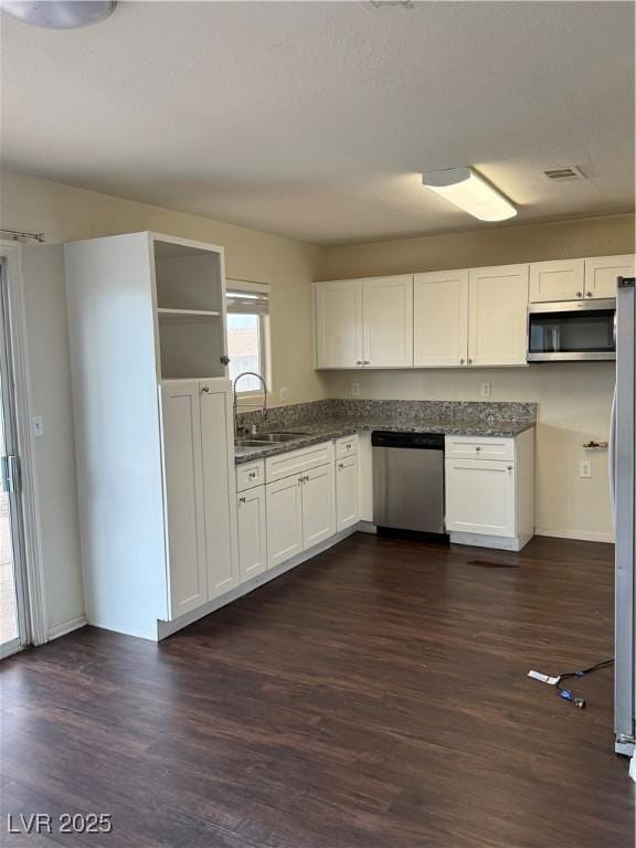 216 Night Fall Ter, Henderson, NV 89015 - kitchen featuring appliances with stainless steel finishes, dark wood finished floors, and white cabinetry