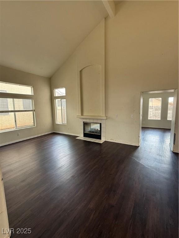 216 Night Fall Ter, Henderson, NV 89015 - unfurnished living room with high vaulted ceiling, a fireplace, dark wood-style flooring, and beamed ceiling