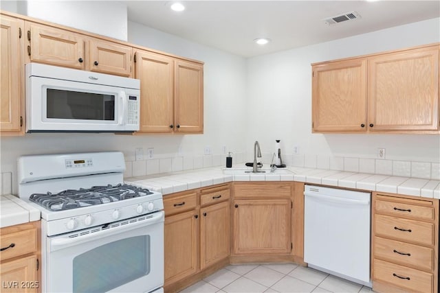 2219 Rugged Mesa Dr, Laughlin, NV 89029 - kitchen with white appliances, light brown cabinetry, recessed lighting, and light countertops